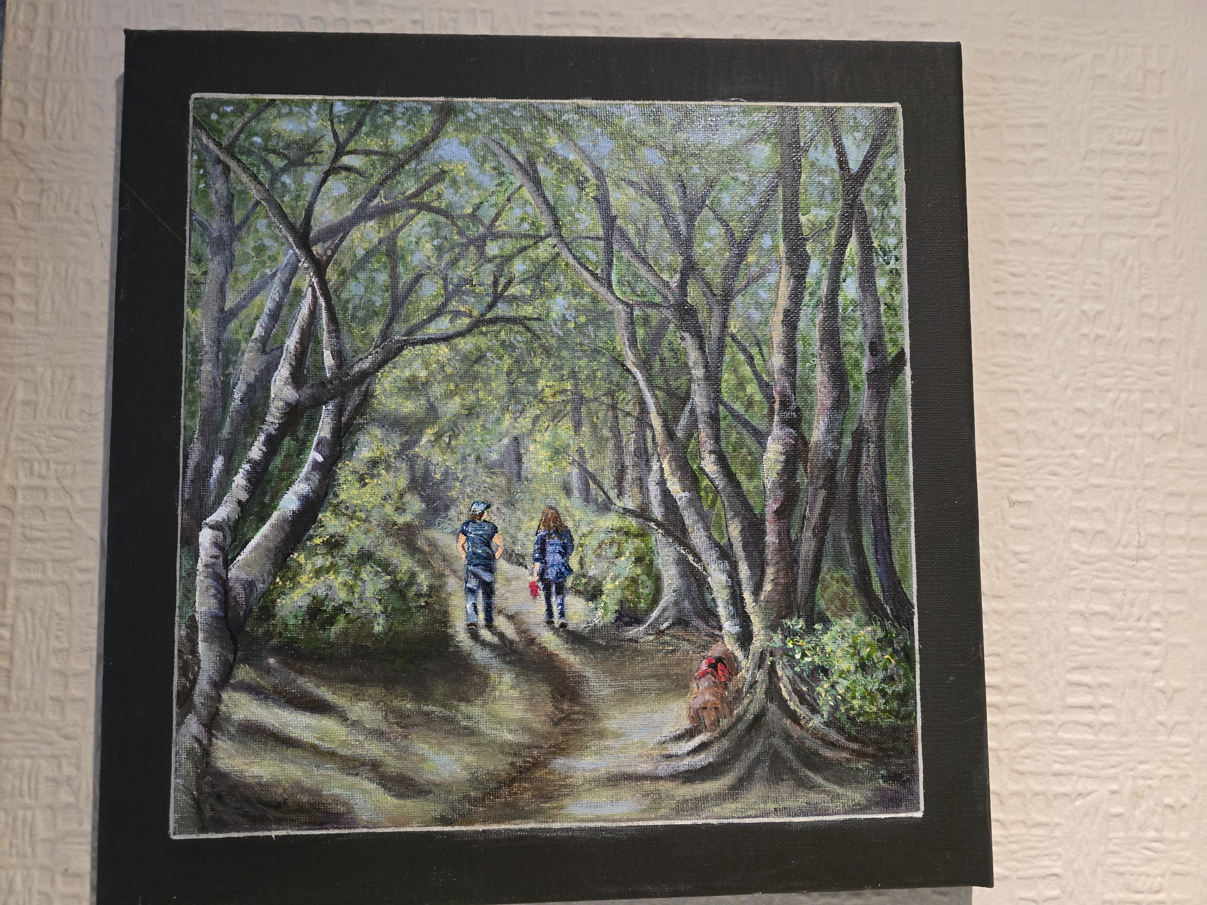 Woodland Walk - Two figures walk along a shaded forest path, surrounded by arching trees and dappled light. The comp... Woodland Walk - Acrylic on Canvas | Various